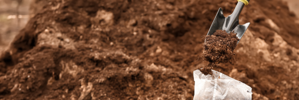 Brown soil and hand shovel