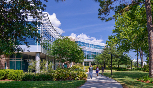 Petway Hall with students walking down the sidewalk