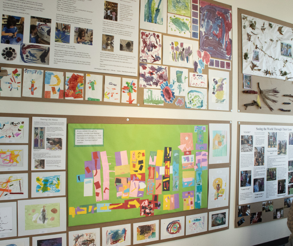 Gallery wall of children's art work and photos of the artistic process. 