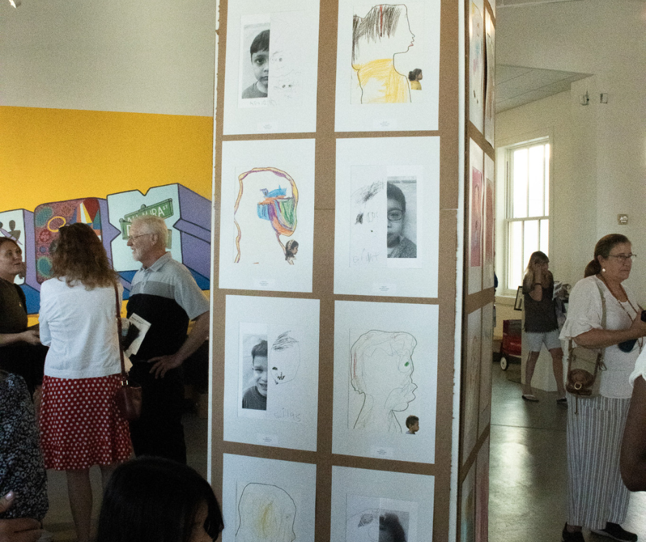 UNF preschooler's sketches of their faces on gallery wall