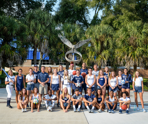 UNF student athletes gathered together outside on UNF campus