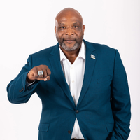 Ervin Lewis in blue suit making a fist with ring on his finger