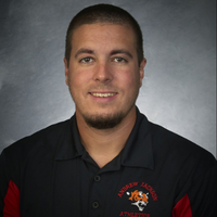 Headshot of Jason Snader in black and red polo