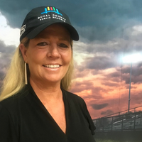 Headshot of Tammie Talley smiling with blonde hair and a pearl headband