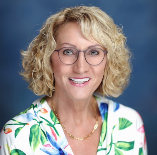 headshot of Laura Boilini wearing glasses and a floral shirt