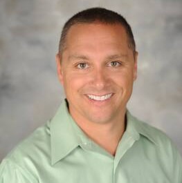 Headshot of Michael Binder in a green button-up shirt