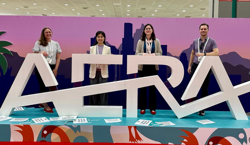 AERA Conference picture in front of the entrance sign 2026