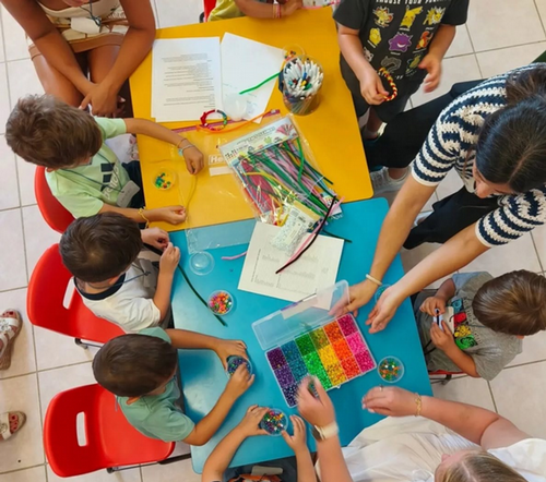 Overhead shot of UNF students and faculty being creative with young students