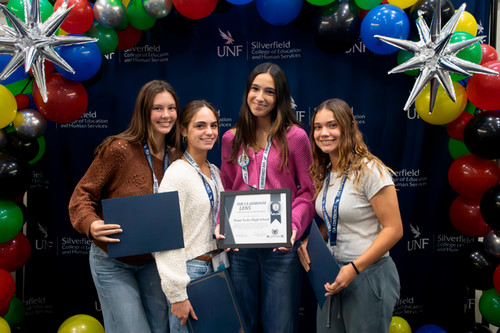 FEA high school students holding their awards at UNF