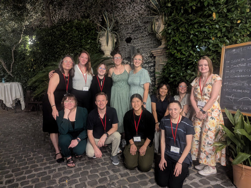 UNF students and faculty posing on a cobblestone street in Rome 