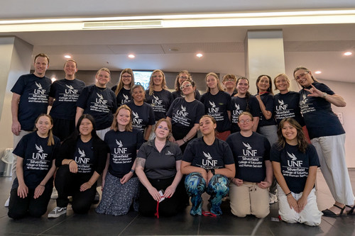 UNF students and faculty wearing UNF Silverfield t-shirts in Italy
