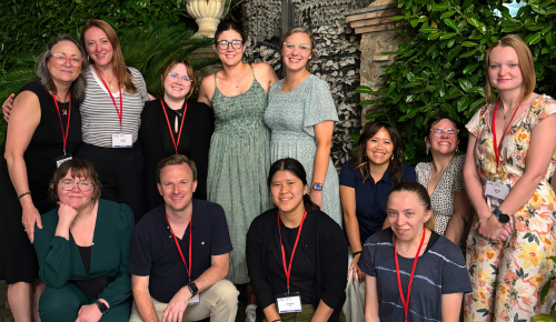 A group of students and faculty smile during a study abroad trip to Italy.