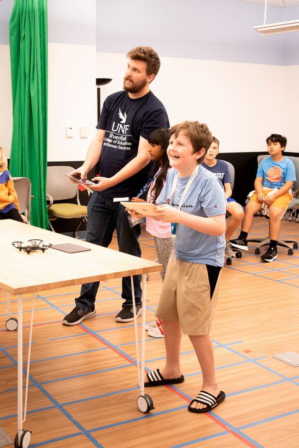 Ivan and a camper on iPads flying drones