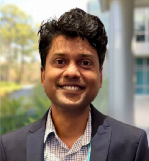 Headshot of Rakesh Maurya with blurred UNF background
