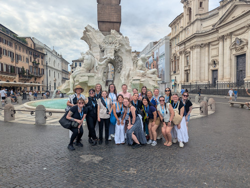 UNF students and faculty smiling in front of historic Roman fountain 