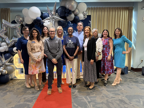 Group of UNF SCOEHS faculty posing on red carpet at STARS celebration.