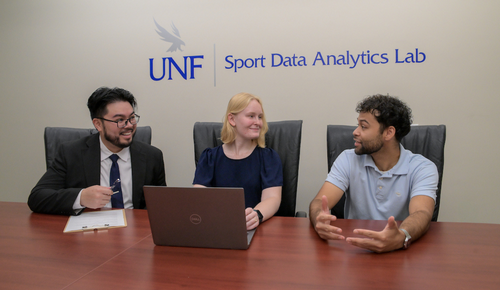 Three UNF SDAL students sitting at desk on computer