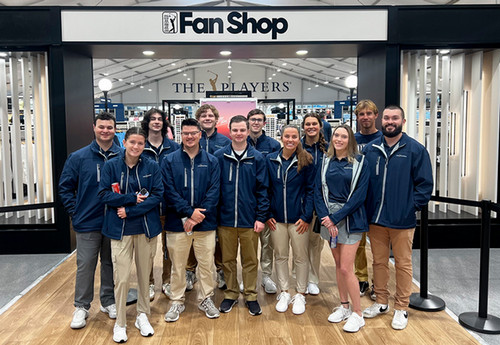 Students pose in front of the Fan Shop at TPC Sawgrass.