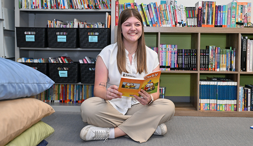 Mikayla Waters reading book to classroom in deaf education
