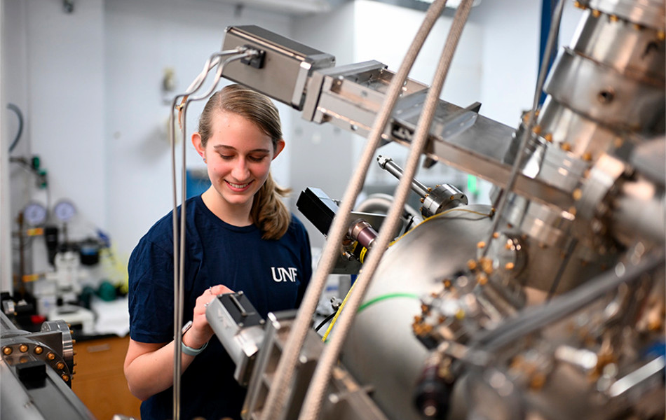 Student working on machinery in a lab