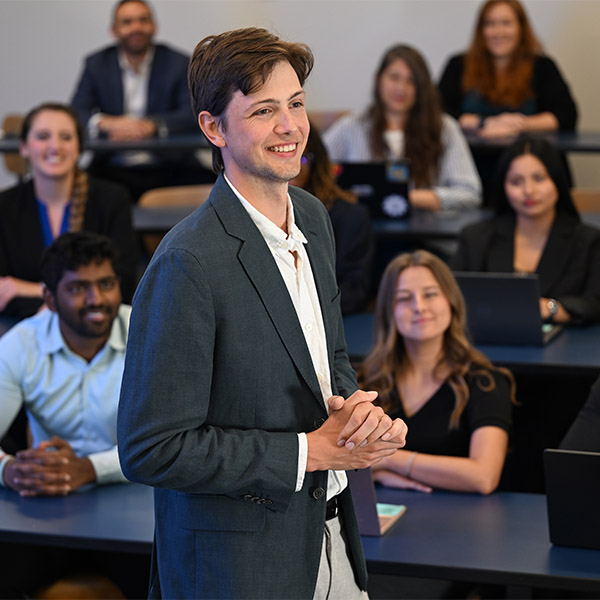 Student in blazer standing up in front of class
