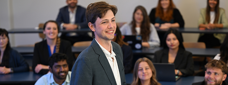 Student standing in front of classroom full of students