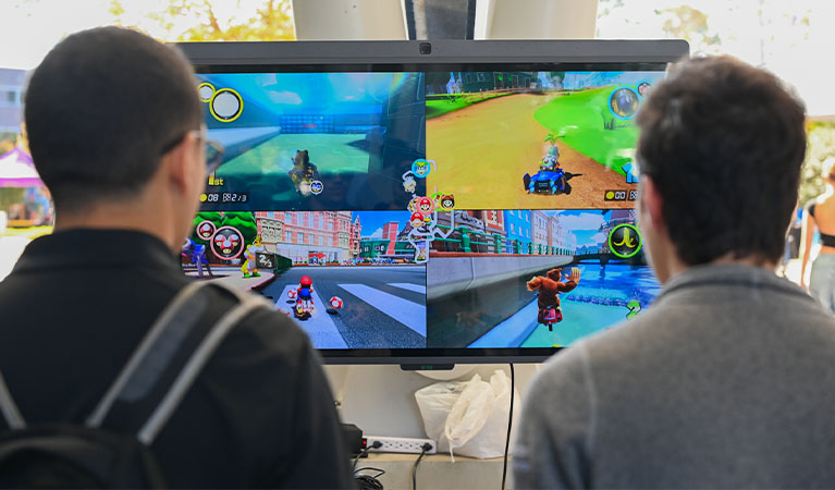 Two students playing mario kart 