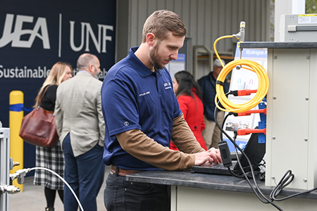 jea event on campus with someone at a laptop