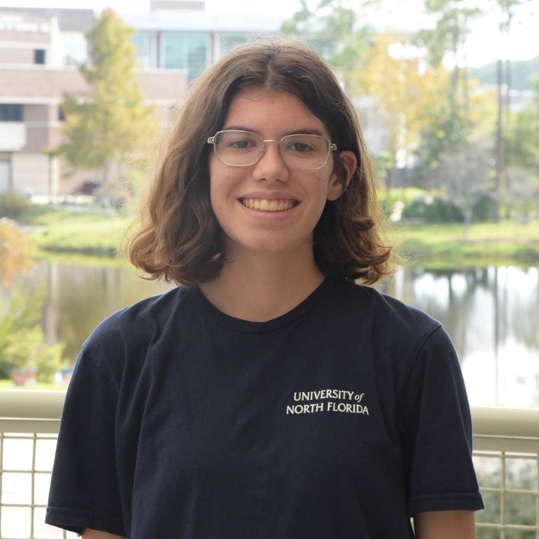 CJ is wearing a black shirt and glasses