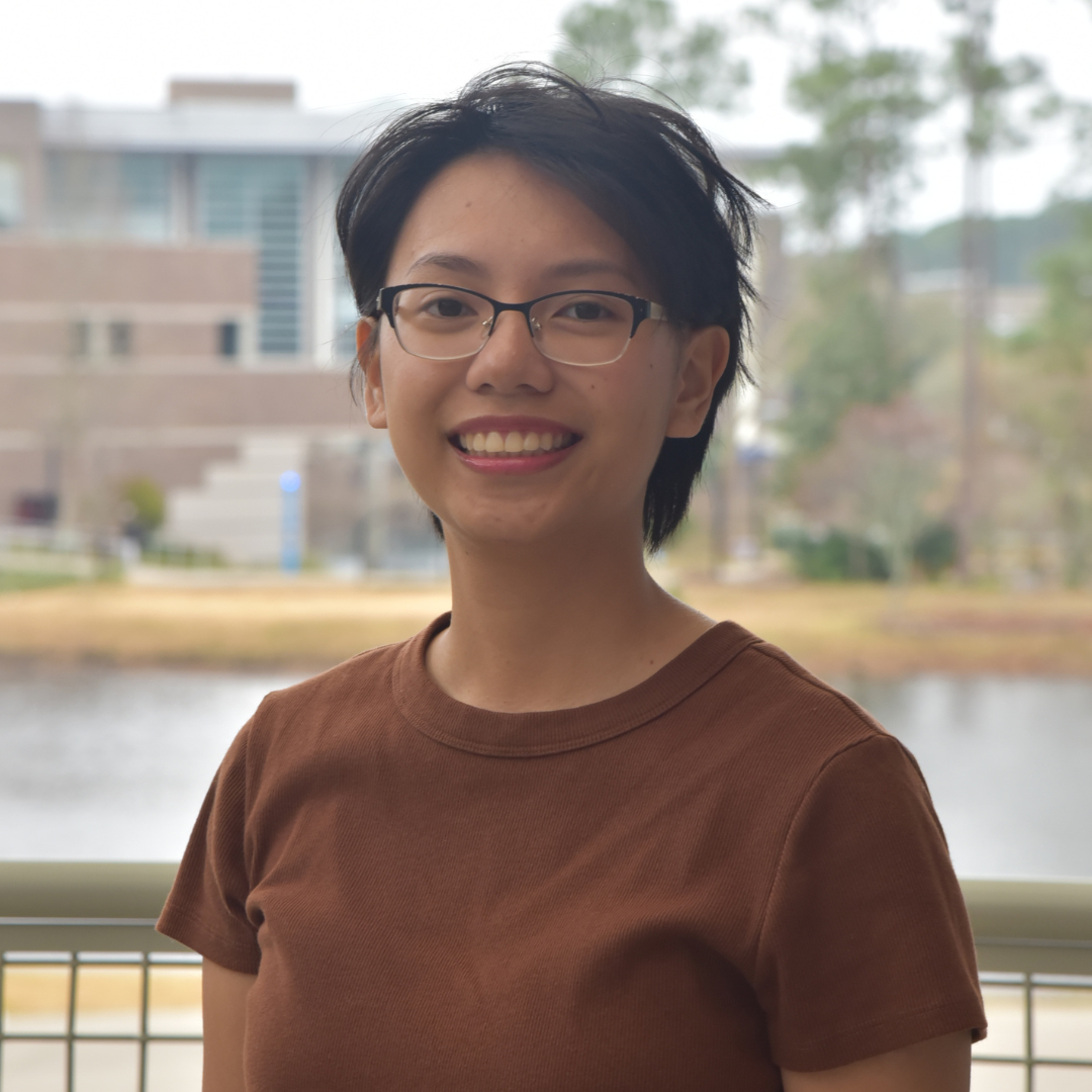 Cliona has short hair and is wearing glasses