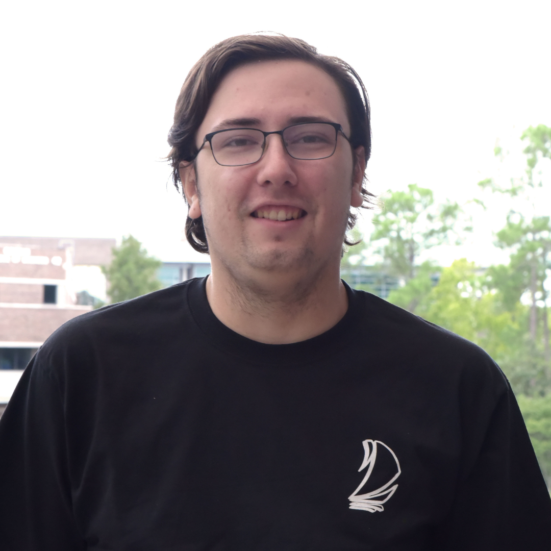 Ethan is wearing a black Spinnaker shirt