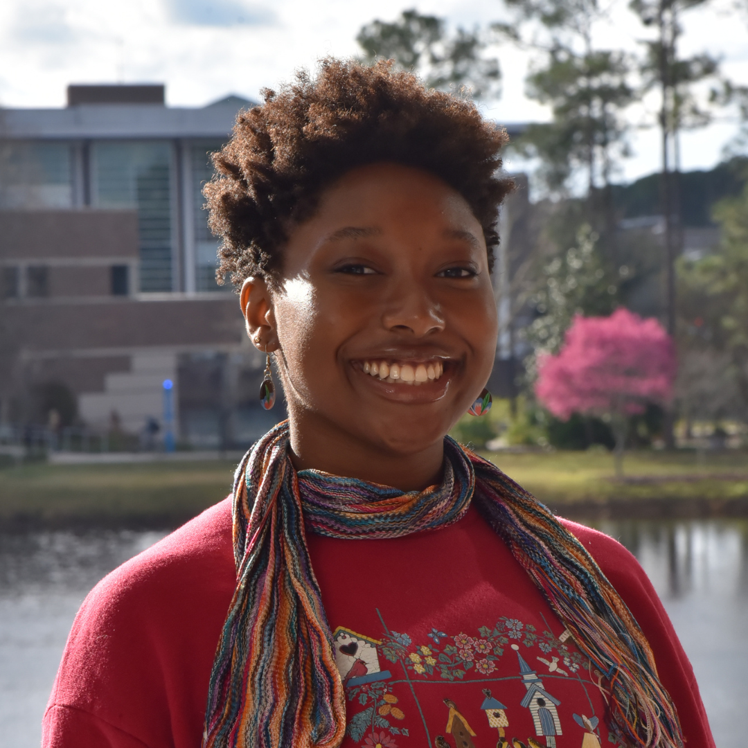 Everney is wearing a red sweater