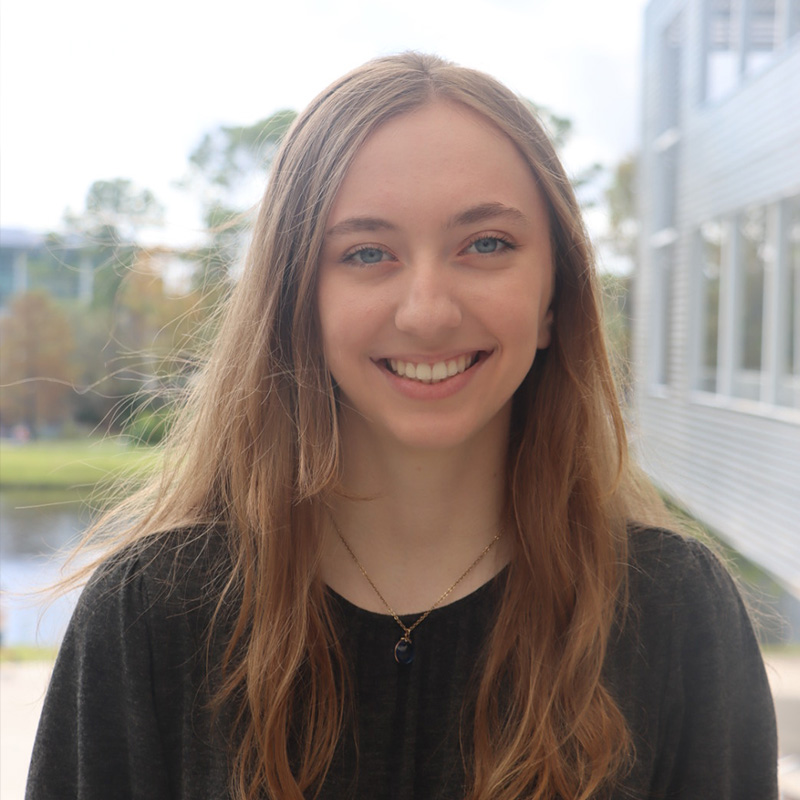 Kara in a black shirt in front of the student union