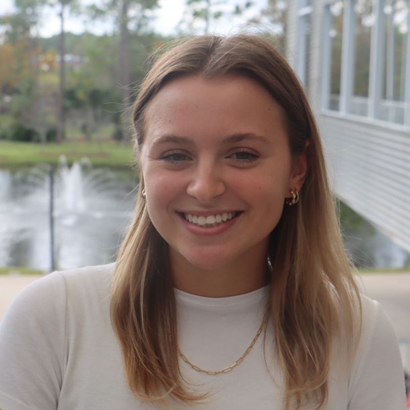 Mallory in a white shirt outside of student union