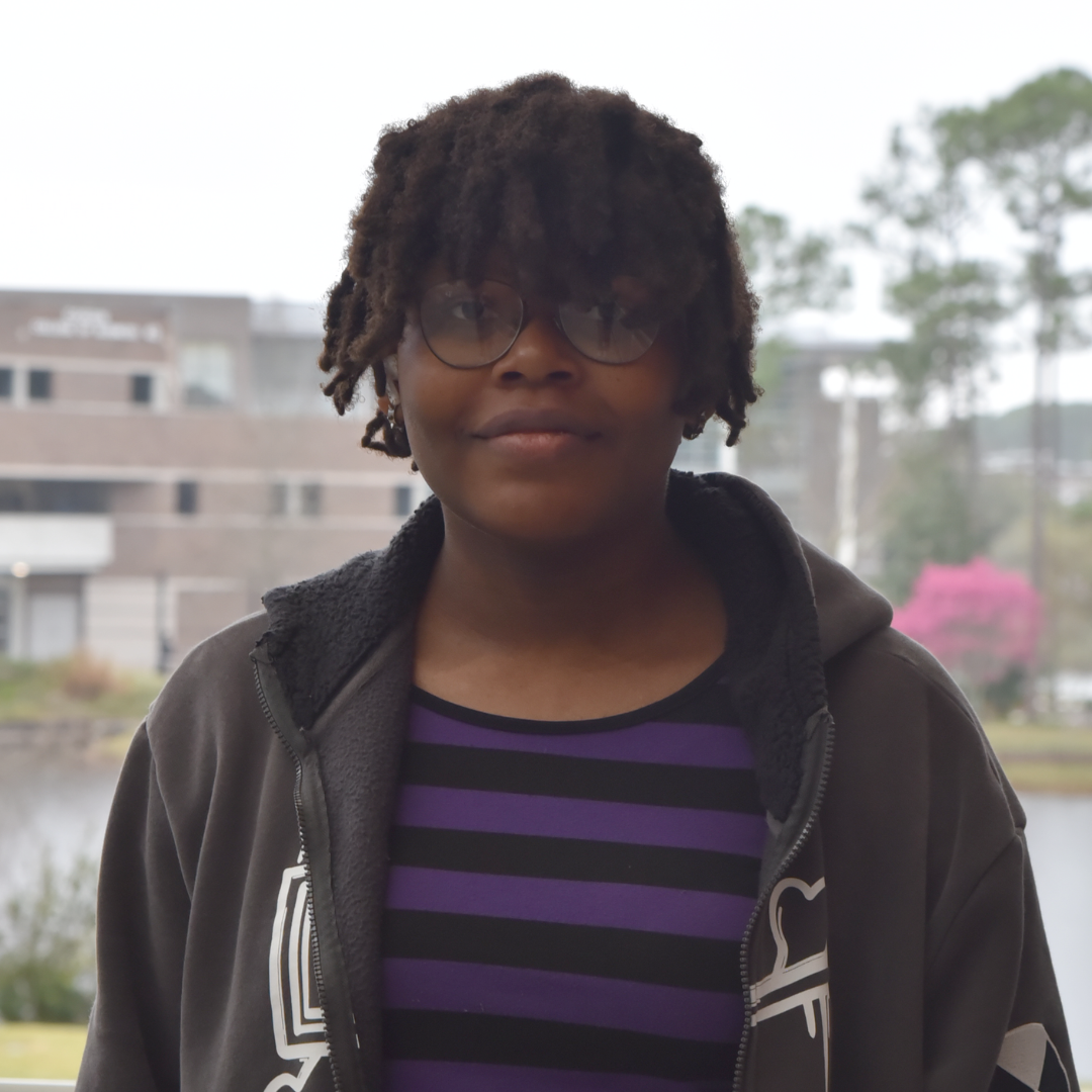 Rachel is wearing a purple and black shirt