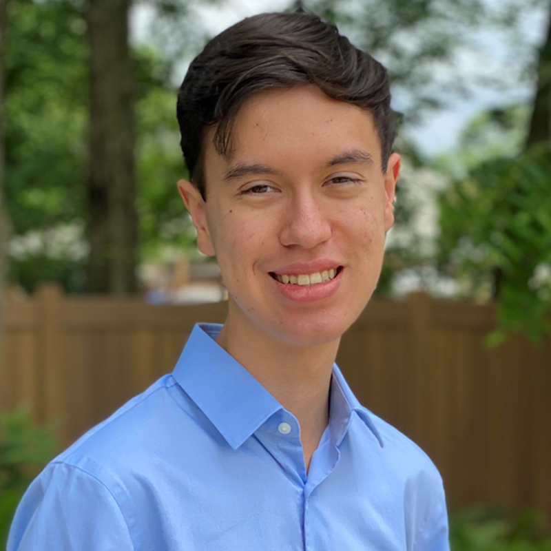 Carter Mudgett in a blue shirt standing outside