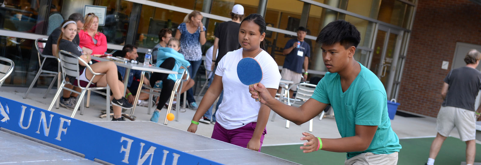 Students playing ping pong on campus