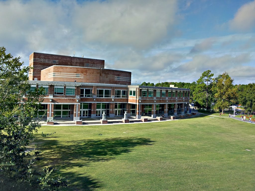 large grass lawn in front of brick buildings
