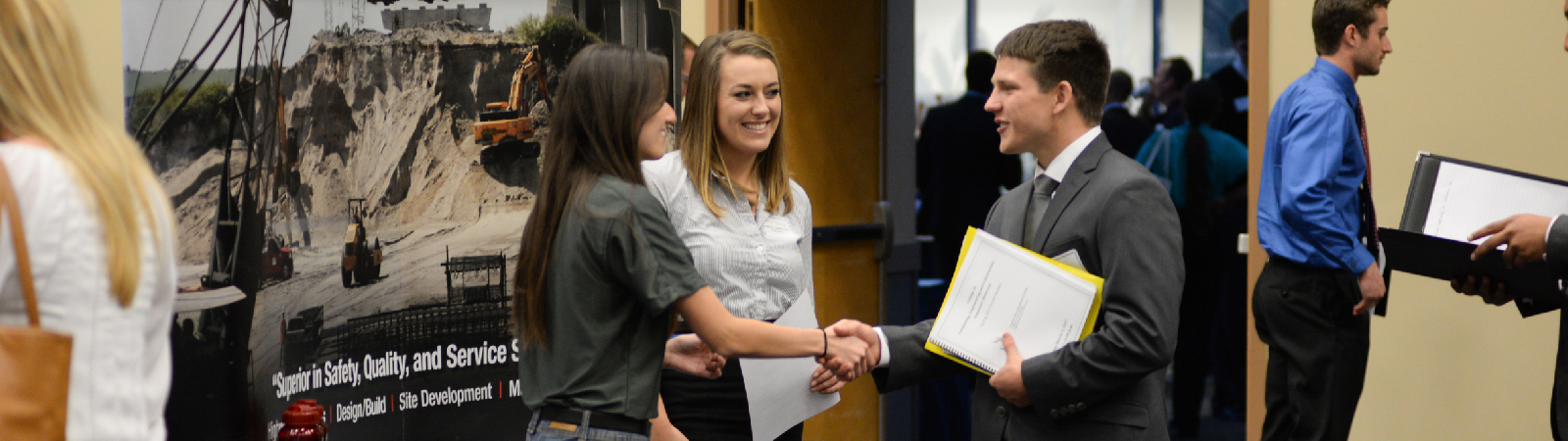 UNF student shaking hands and talking with someone at a career fair