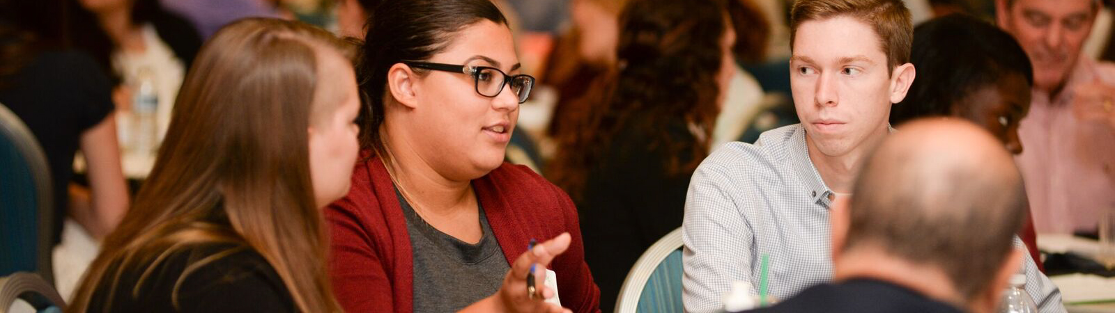 Students at a table in discussion at the annual Leadership Summit