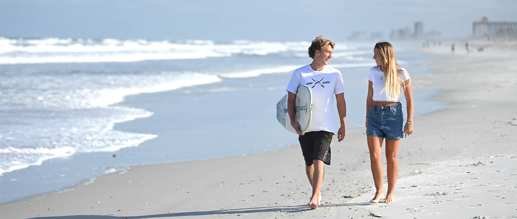 two students walking on the beach