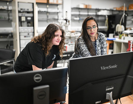 faculty member instructing a student