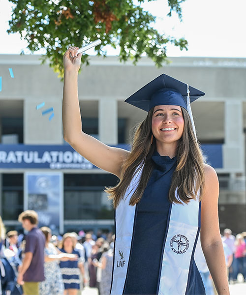 graduate celebrating outside of unf arena