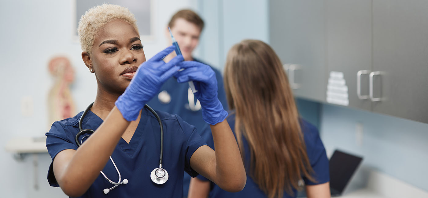 nursing student learning to preparing a syringe for injection