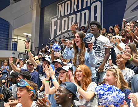 students cheering at a basketball
