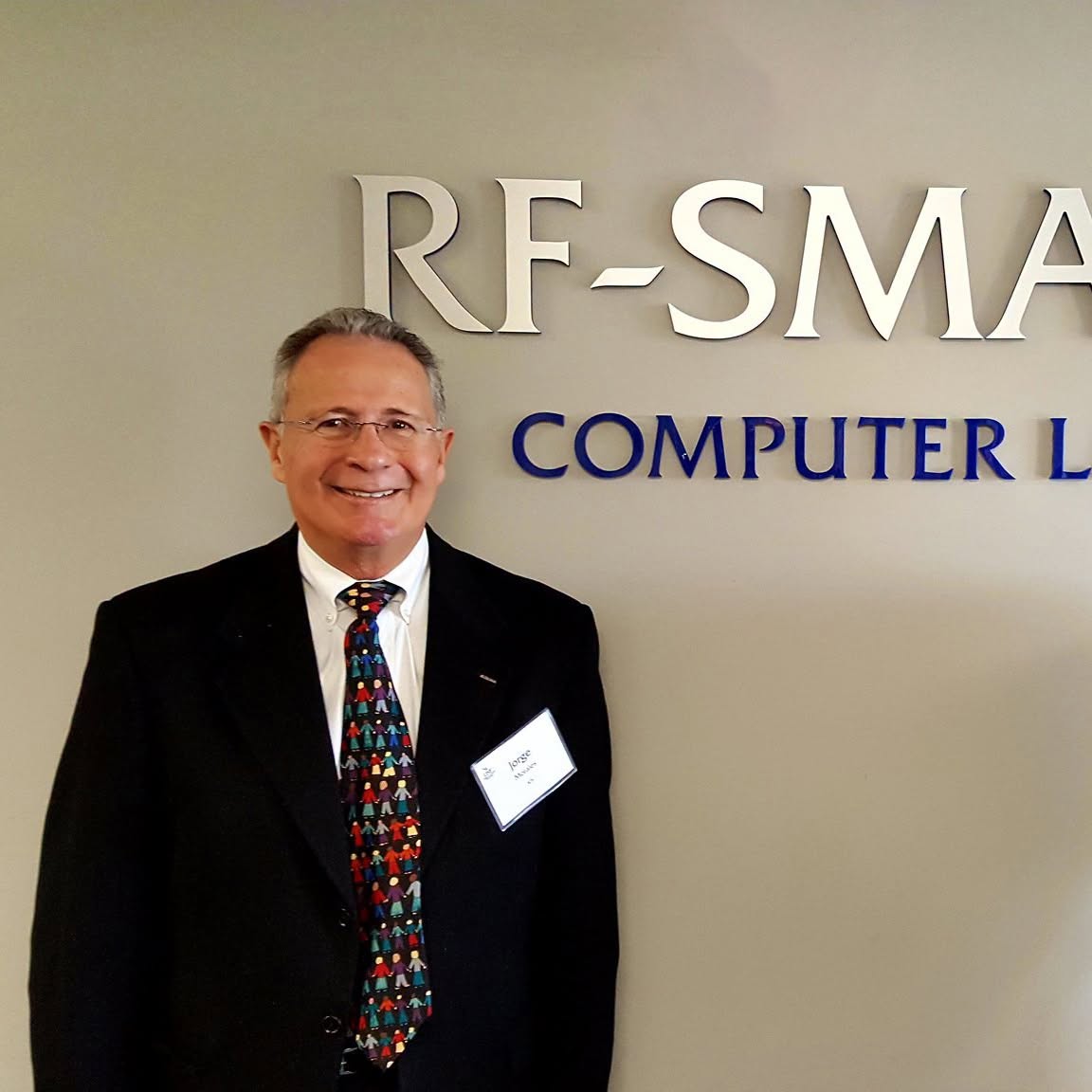 Jorge Morales standing in front of RF-SMART signs