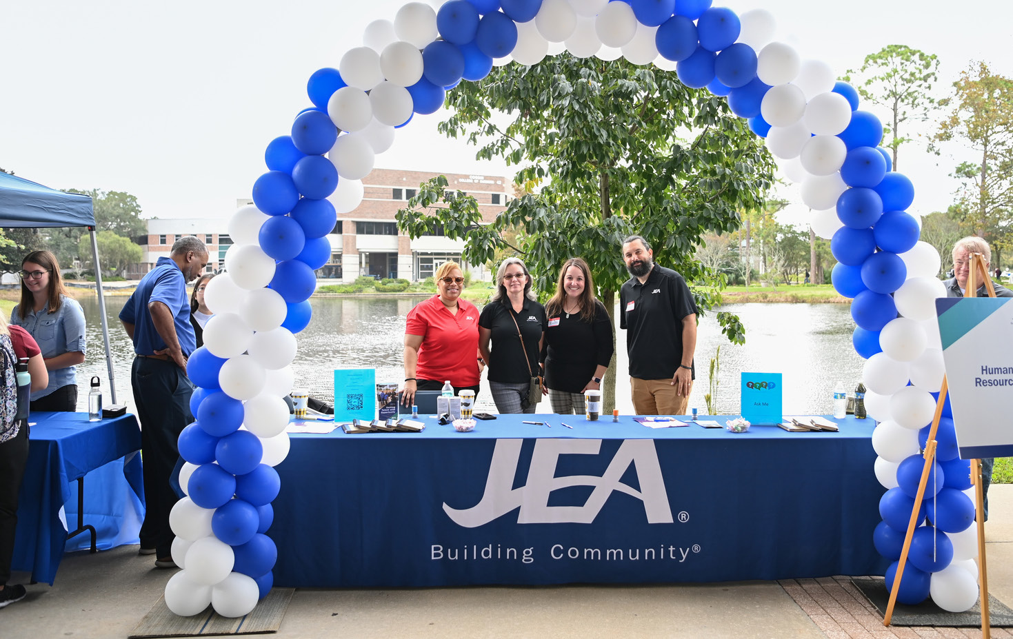 JEA employees under a balloon arch