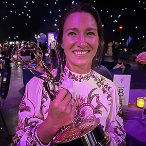 Photo of Nicole McNamara holding an award