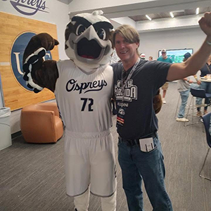 Photo of Rich Phelan next to UNF Osprey Mascot