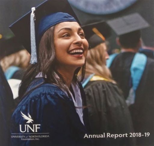 Cover of the 18-19 annual report with graduate in cap and gown looking up